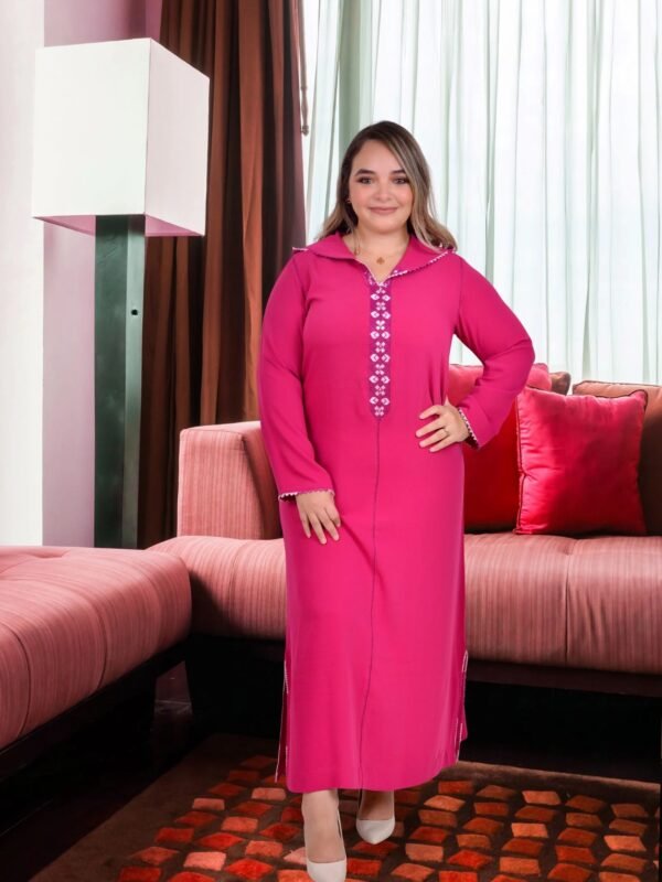 Handmade pink djellaba with elegant white embroidery and refined traditional detailing.