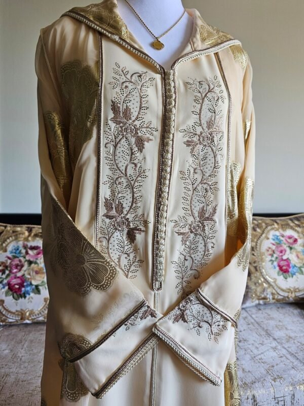 Beige djellaba with elegant brown embroidery and refined traditional detailing.